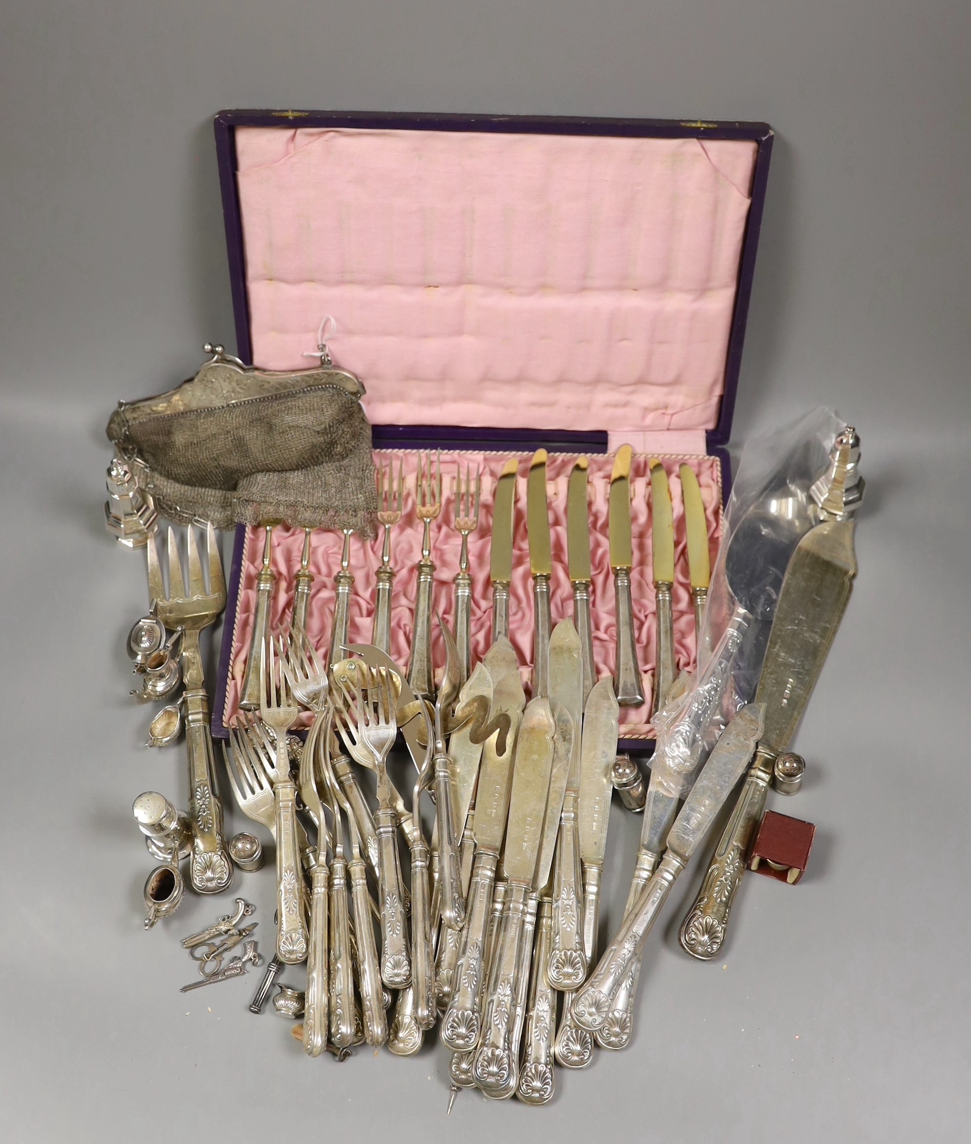 A pair of George VI silver fish servers, Carrington & Co, London 1939 and eleven pairs of matching fish eaters, together with a continental white metal skewer, a modern silver handled cake slice and cheese knife, a lady'